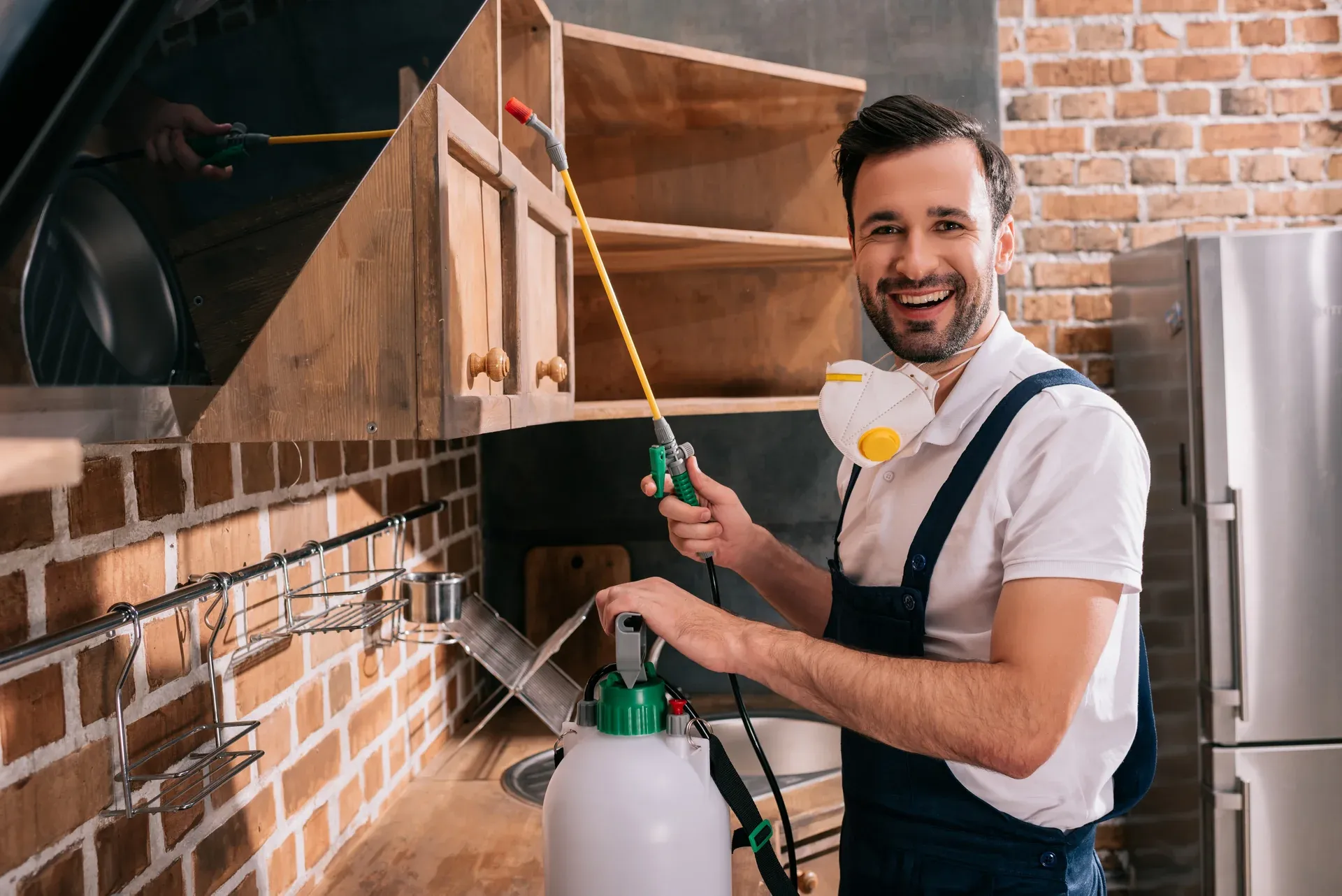 Pest control technician spraying interior for general household pests