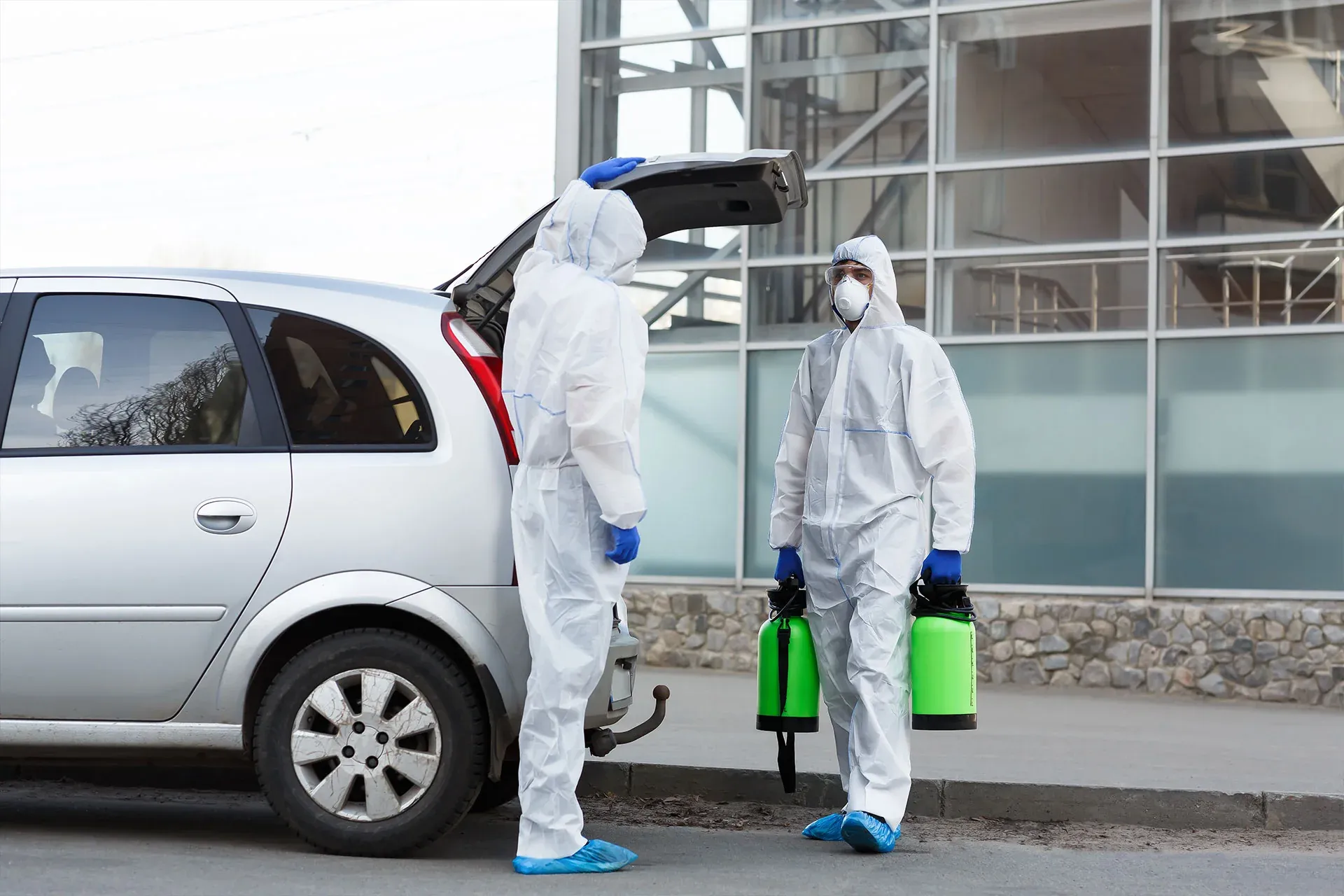 Pest control technicians loading professional equipment for a service call